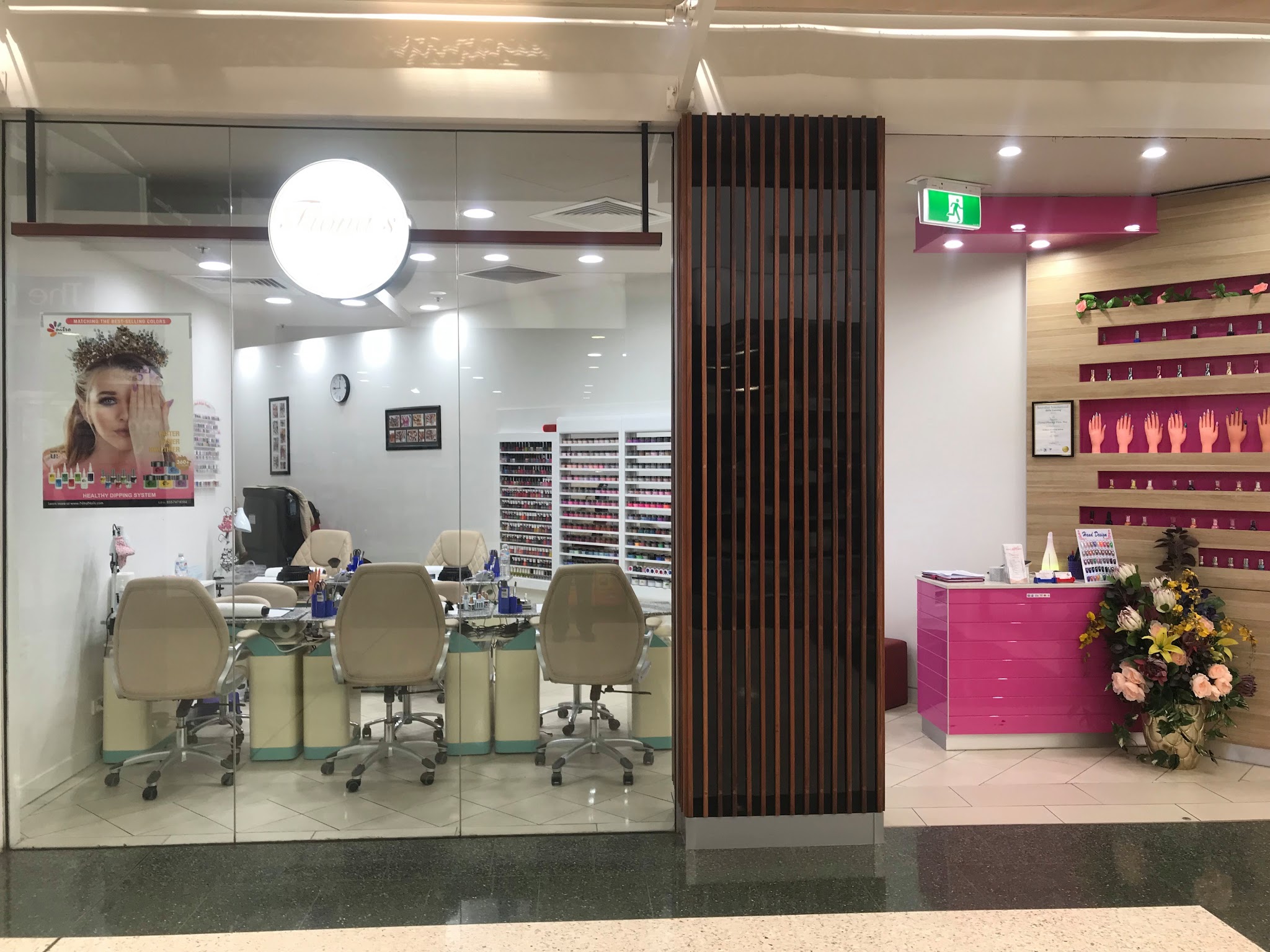 The Fiona's Nail Creations shopfront in Clifford Gardens Shopping Centre, with its pink reception desk and polish wall