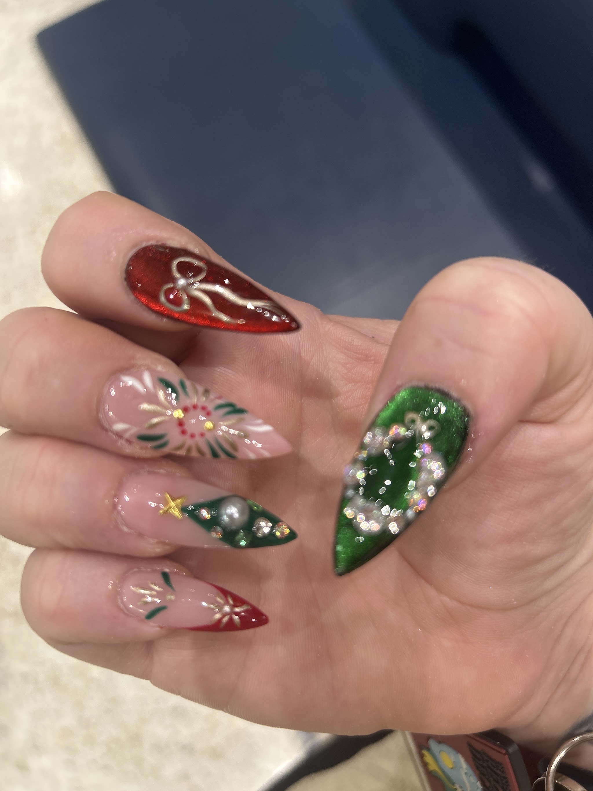 Christmas nail art in red, green and nude with bows and ornaments